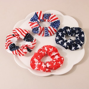 Set of four American flag pattern scrunchies with stars and stripes on a white plate