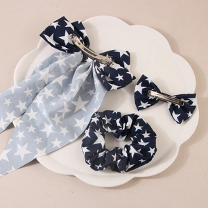 Three-piece hair accessory set featuring blue star print bows and a large scrunchie