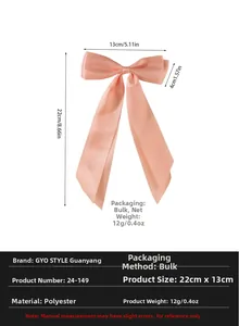 Detailed view of pink ribbon bow hair clip with dimensions of 22cm x 13cm for styling