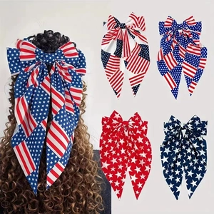 Detailed close-up of large polyester bow hair clips featuring American flag patterns