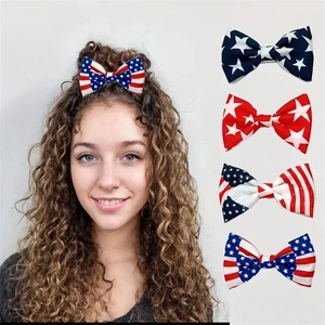 Detail view of five assorted American flag bow hair clips with stars and stripes patterns