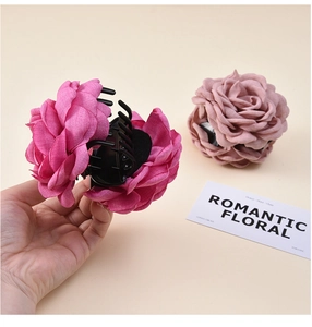 Detailed view of large chiffon flower hair claws in rose pink and dusty mauve colors