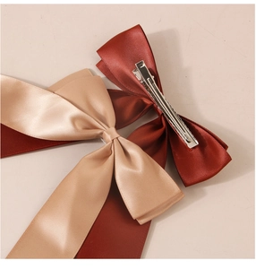 Close-up of double-layered satin bow hair clip with metal alligator clip back view