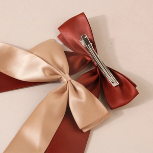 Elegant satin ribbon bow hair clips in wine red and champagne gold with metal duckbill clips