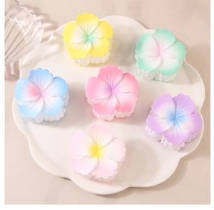 Detailed set of 6 matte flower hair claws in macaron gradient colors on a white tray