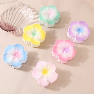 Matte gradient flower hair claws in six pastel colors including blue pink and yellow