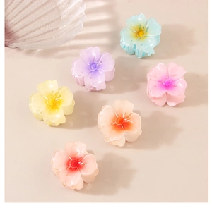 Close-up of 4cm gradient flower hair claws in six vibrant colors on neutral background
