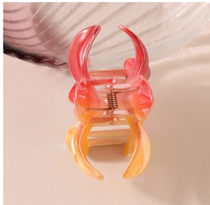 Close-up of pink gradient frangipani hair claw clip with durable metal spring and resin teeth