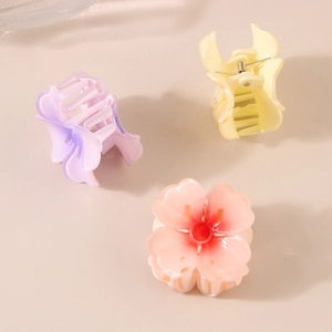 Three-piece set of floral claw clips in pink, purple, and yellow with matte finish