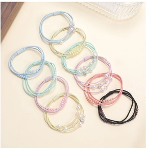 Close-up of multi-colored pearl beaded hair ties with elastic bands and crystal accents
