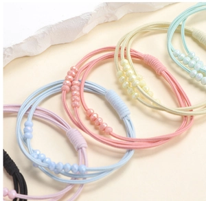 Detail of high-elastic multi-strand hair ties with iridescent faceted beads in pastel colors