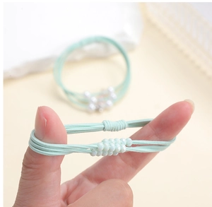 Elastic mint green multi-strand hair scrunchie with matte beads shown in high stretch
