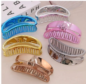 Detailed close-up showing large metallic hair claws in various vibrant electroplated colors