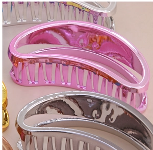 Close-up of metallic electroplated claw clips in pink, silver, and gold finishes