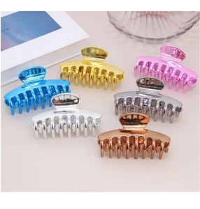 Macro shot of six metallic shark hair clips in electroplated colors and polished finish