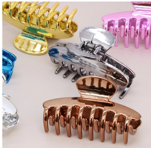 Detailed close-up showing metallic finish and spring structure of large hair claw clips