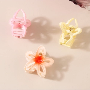 Elegant hollow floral hair claw clips with gradient colors in pastel pink and yellow