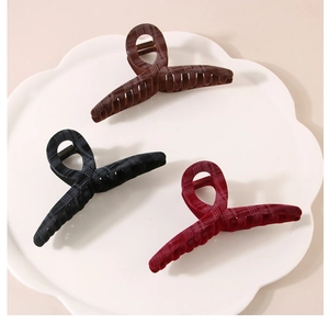 Detailed view of large plaid hair claws in coffee, black and burgundy for thick hair