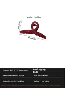 Detail of 11cm dark red flocked hair claw clip with resin base and twisted design