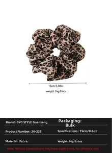 Detail view of oversized leopard print scrunchie showing 15cm diameter size and soft fabric