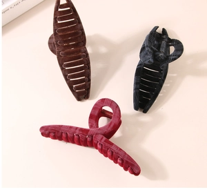 Close-up of three 11cm flocked hair claws in burgundy, coffee, and black colors