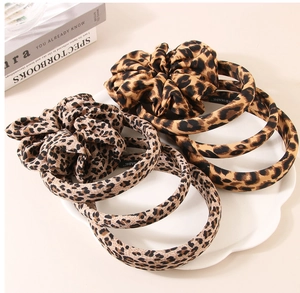 Detail of handmade leopard print headband with fabric texture and interior handmade stamp