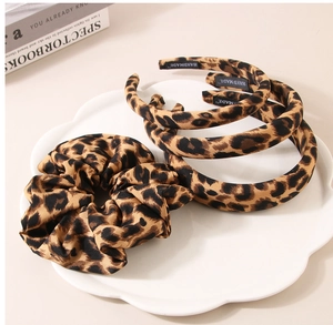 Detail of leopard print scrunchie and headbands set with handmade fabric label