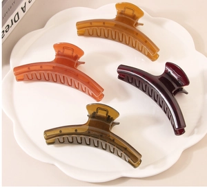 Set of four large acrylic hair claws in amber, burgundy, green and brown tones