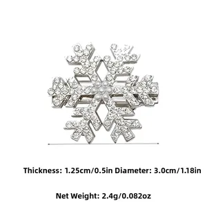 Detailed view of silver snowflake hair clip with rhinestones and central pearl detail