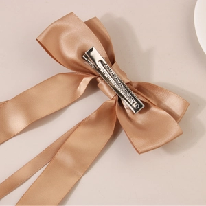 Elegant champagne gold satin bow hair clip with long ribbons and metal duckbill clip