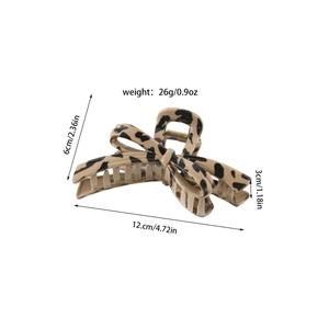 Close-up of a leopard print large hair claw clip with cross-tooth design and size specs