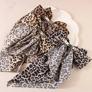Three leopard print chiffon bow hair clips with long ribbons in brown, beige, and black