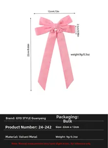 Detail of pink velvet bow hair clip with long ribbons and metal fastener material