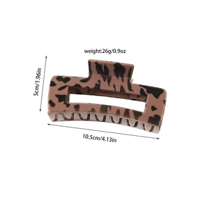 Detail of leopard print hair claw clip showing resin texture and large rectangular design