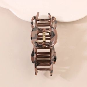 Classic leopard print hair claw clip with glossy finish and gold spring for women
