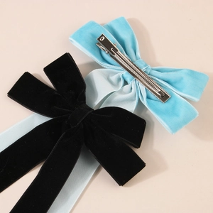 Velvet bow hair clips in black and light blue with metallic spring back fastener
