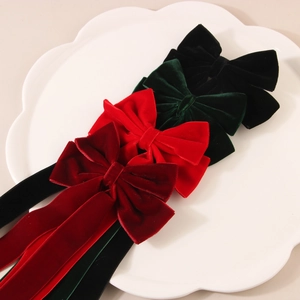 Velvet bow hair clips with long ribbons in red, green, and black for elegant styling
