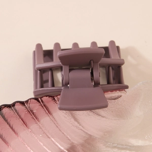 Matte purple square shark hair clip with strong metal spring on beige background