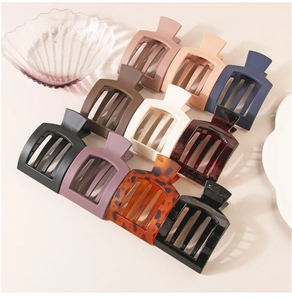 Flat lay of large square hair claws in ten various matte and tortoiseshell finishes