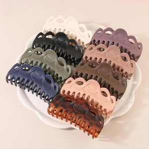 Set of nine large matte hollow wavy hair claw clips in various Morandi and tortoiseshell colors