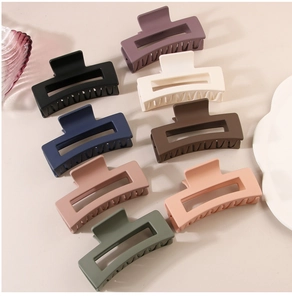Detailed set of nine matte Morandi rectangular hollow hair claws for daily styling