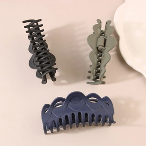 Set of large matte French hair claws in black, olive green, and navy blue with heart cutouts