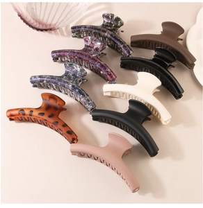 Detail view of colorful large hair claw clips in marble and matte finishes for thick hair