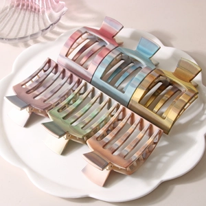 Set of 6 colorful marble pattern PC square claw clips for thick hair on a floral plate