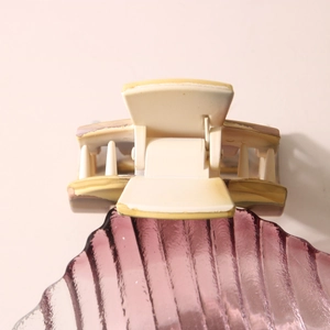 Elegant cream-colored hair claw clip with subtle brown edges on decorative shell plate