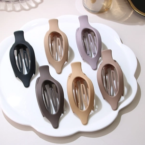 Set of 6 large matte flat round hair clips in assorted neutral colors for hair styling