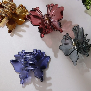 Set of five elegant hollow butterfly hair claws in amber, burgundy, and green resin