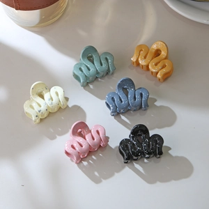 Close-up of 6 wave-shaped hair clips in Morandi colors with splatter ink patterns