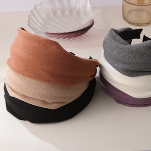 Solid color wide fabric headbands in neutral tones with twist design for women