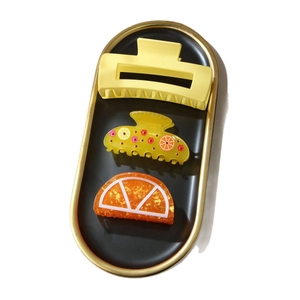Three-piece set of colorful hair clips with orange patterns and matte textures